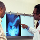 A doctor goes over a patient’s X-ray as part of a screening for colon cancer.
American Cancer Society/Getty Images